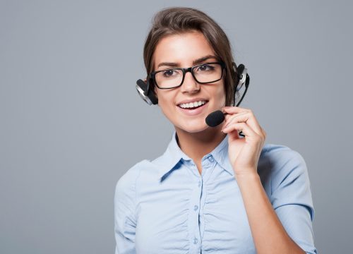 female-call-center-agent-posing-with-headphones-with-mic